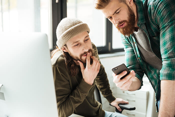 men-colleagues-office-using-mobile-phone (1)